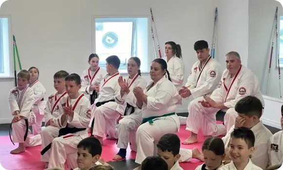 Children breaking boards at martial arts camp